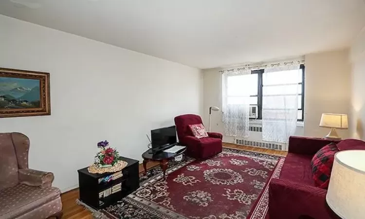 Virtually Staged-Living room with wood finished floors and baseboards