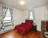 Bedroom with radiator and hardwood / wood-style floors