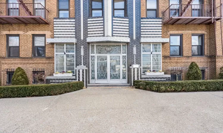 View of exterior entry featuring brick siding