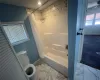 Bathroom featuring shower / bathtub combination with curtain, baseboards, and marble finish floor