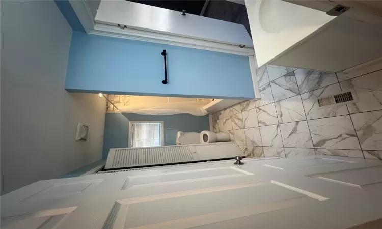 Bathroom featuring visible vents, toilet, shower / bath combo, marble finish floor, and vanity