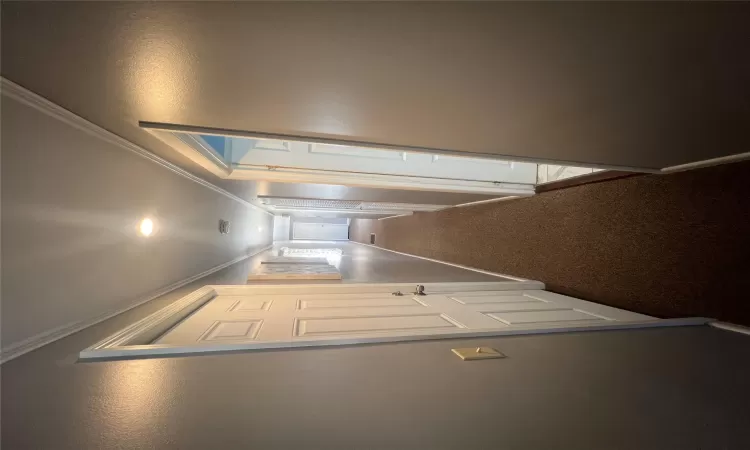 Hallway with visible vents, crown molding, baseboards, carpet, and recessed lighting