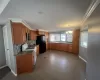 Kitchen featuring white gas range, backsplash, freestanding refrigerator, crown molding, and a chandelier