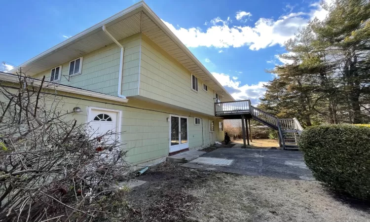 Rear view of property with a patio, stairway, and a wooden deck