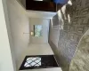 Entryway featuring baseboards, an inviting chandelier, and a baseboard radiator