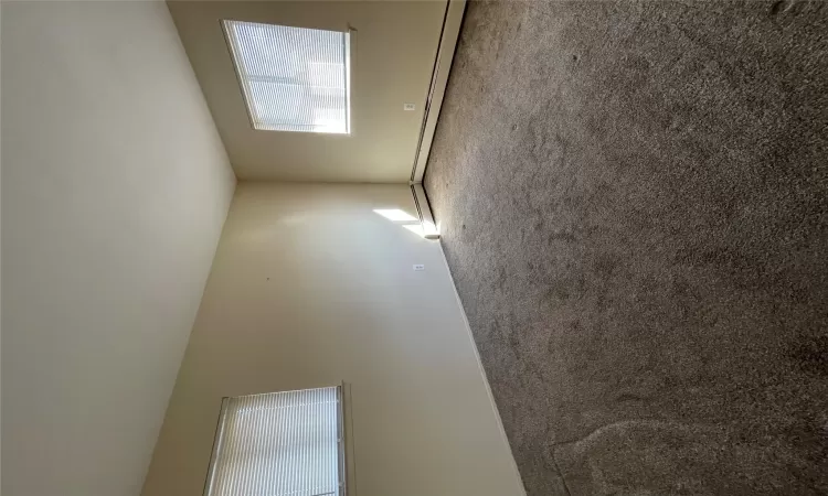 Spare room featuring baseboard heating and carpet floors