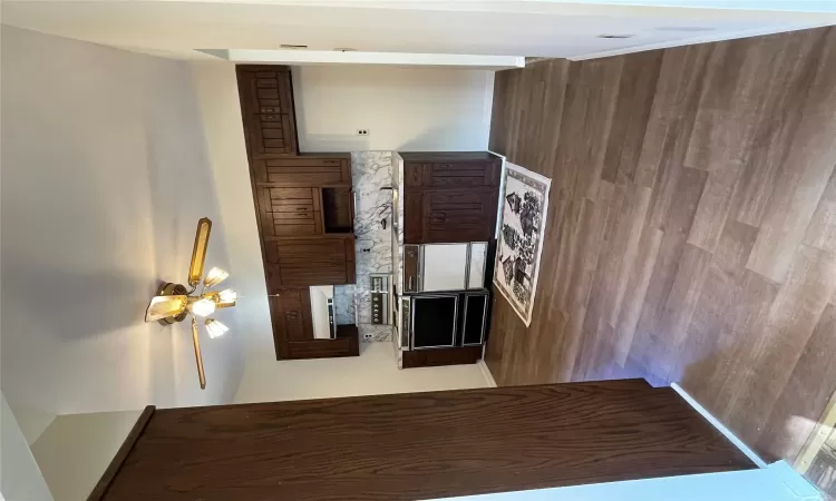 Kitchen featuring backsplash, ventilation hood, dark brown cabinetry, dishwasher, and range