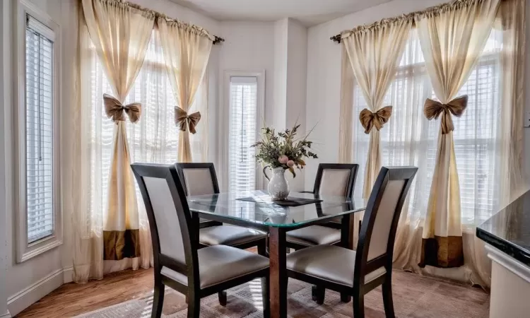 Dining area with light wood-style floors