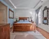 Bedroom with visible vents, baseboards, and a tray ceiling