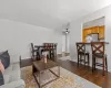 Living area with dark wood finished floors, ceiling fan, and baseboards