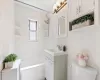 Full bath featuring vanity, washtub / shower combination, tile walls, toilet, and tasteful backsplash