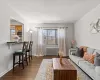 Living room featuring dark wood-style floors, a textured ceiling, radiator heating unit, and baseboards