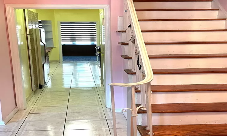 Stairs with tile patterned floors