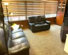 Carpeted living area with a wealth of natural light and wood walls