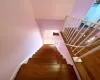 Stairway with baseboards and wood finished floors