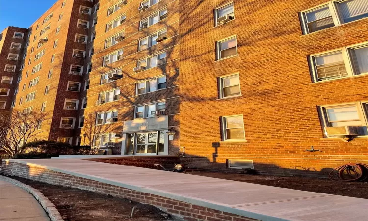 View of building exterior featuring cooling unit