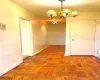 Hall featuring a notable chandelier and baseboards