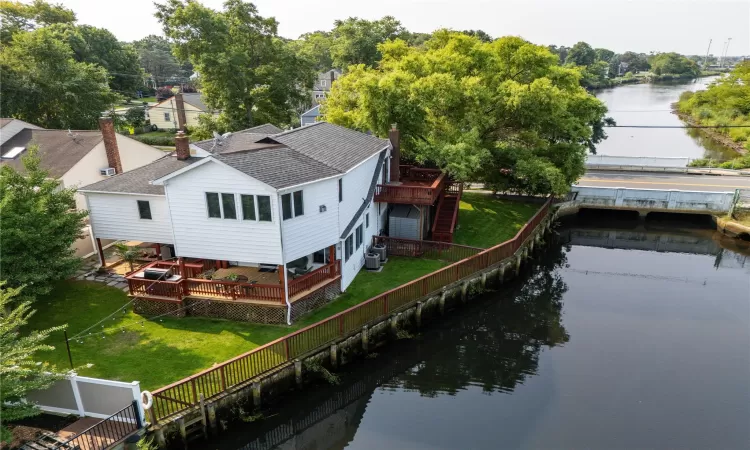 Birds eye view of property with a water view