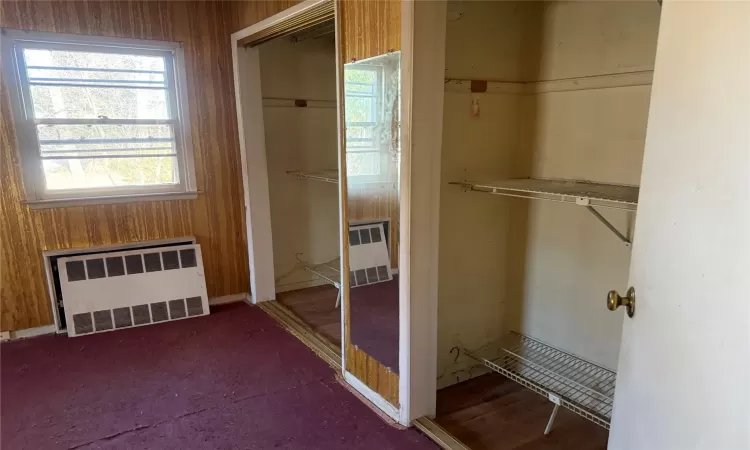 Closet featuring radiator heating unit