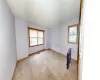 Unfurnished room with visible vents, carpet floors, a textured ceiling, and baseboards