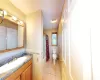 Full bath with tile walls, a wainscoted wall, toilet, tile patterned floors, and a textured ceiling