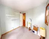 Miscellaneous room with visible vents, carpet flooring, a textured ceiling, and baseboards