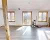 Spare room featuring a wealth of natural light, visible vents, a paneled ceiling, and a baseboard radiator