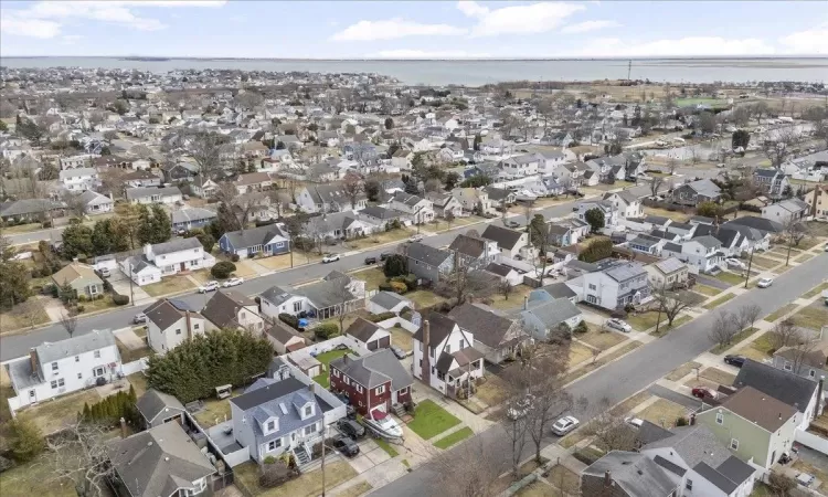 Drone / aerial view with a residential view and a water view