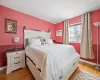 Bedroom with baseboards and wood finished floors