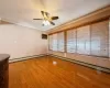 Empty room with plenty of natural light, ornamental molding, a ceiling fan, and light wood finished floors