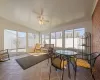 Sunroom featuring ceiling fan and vaulted ceiling