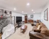 Living area with a baseboard heating unit, carpet flooring, and recessed lighting