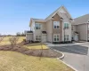 View of front of house with uncovered parking and a front yard