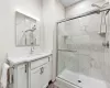 Full bathroom featuring a stall shower and vanity