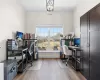 Office space with an inviting chandelier and wood finished floors