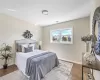 Bedroom featuring visible vents, baseboards, and wood finished floors