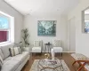 Living area featuring visible vents, baseboards, and wood finished floors