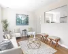 Living room with visible vents, baseboards, and wood finished floors