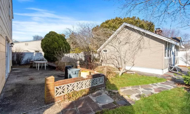 View of yard with a patio area and fence