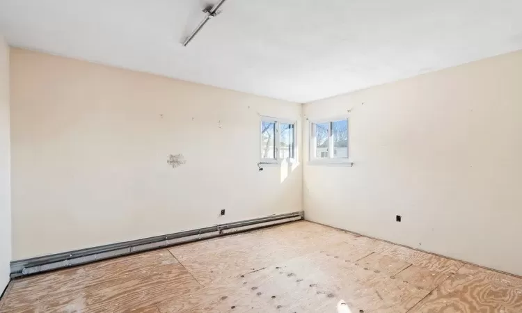 Spare room with a baseboard heating unit