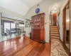 Dining room featuring visible vents, a chandelier, stairs, lofted ceiling, and wood finished floors