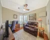 Office space featuring ceiling fan, radiator, light wood finished floors, and ornamental molding