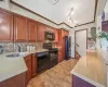 Kitchen with visible vents, backsplash, ornamental molding, black appliances, and a sink