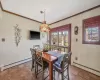 Tiled dining space featuring baseboard heating and crown molding