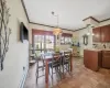 Dining area with light tile patterned floors, a baseboard heating unit, baseboards, and ornamental molding