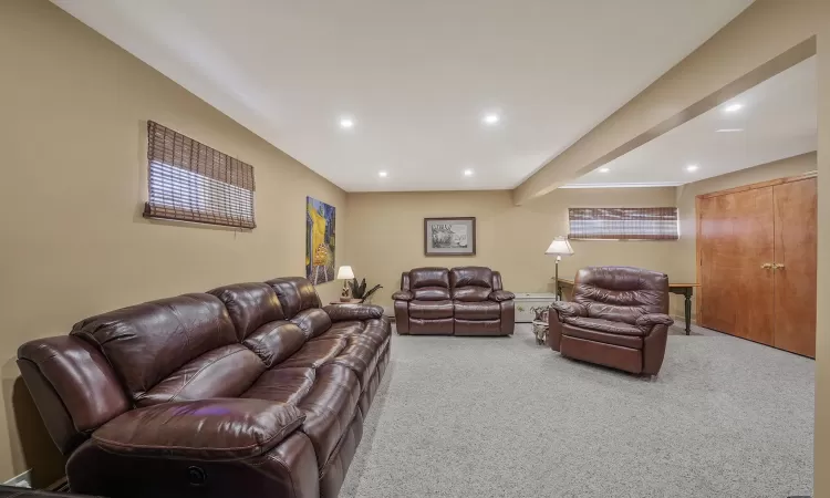 Living area with carpet flooring and recessed lighting