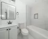 Bathroom featuring vanity, toilet, baseboards, and marble finish floor