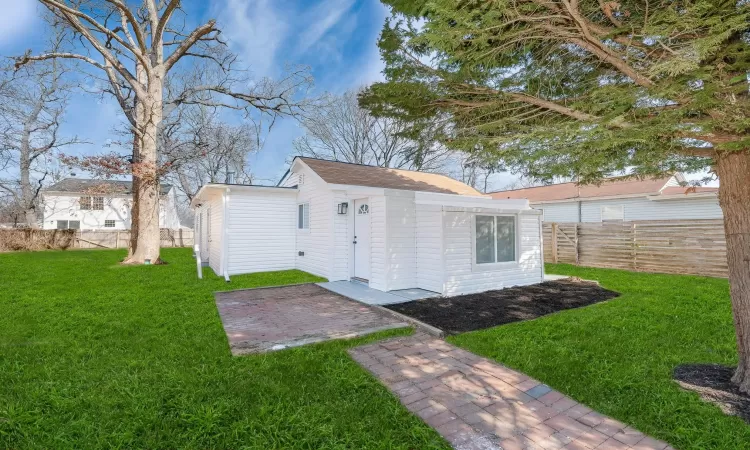 View of outbuilding with a fenced backyard and an outdoor structure