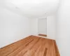 Unfurnished room featuring light wood finished floors and baseboards