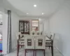 Dining area with tile patterned floors, baseboards, and recessed lighting